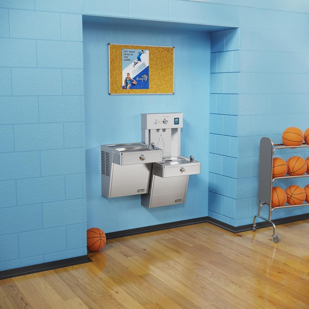 Students using a bottle filling station in a school hallway