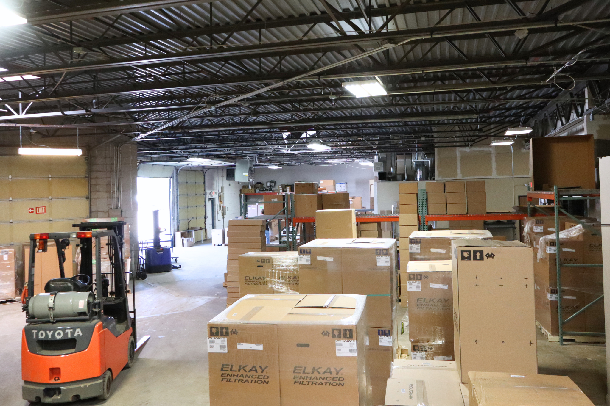 Category Five Technologies warehouse in Livonia, Michigan, with Toyota forklift and Elkay inventory
